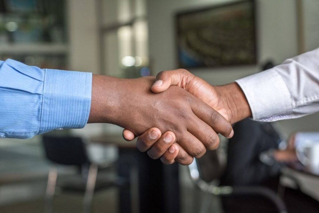 Two logistics partners shaking hands after an agreement