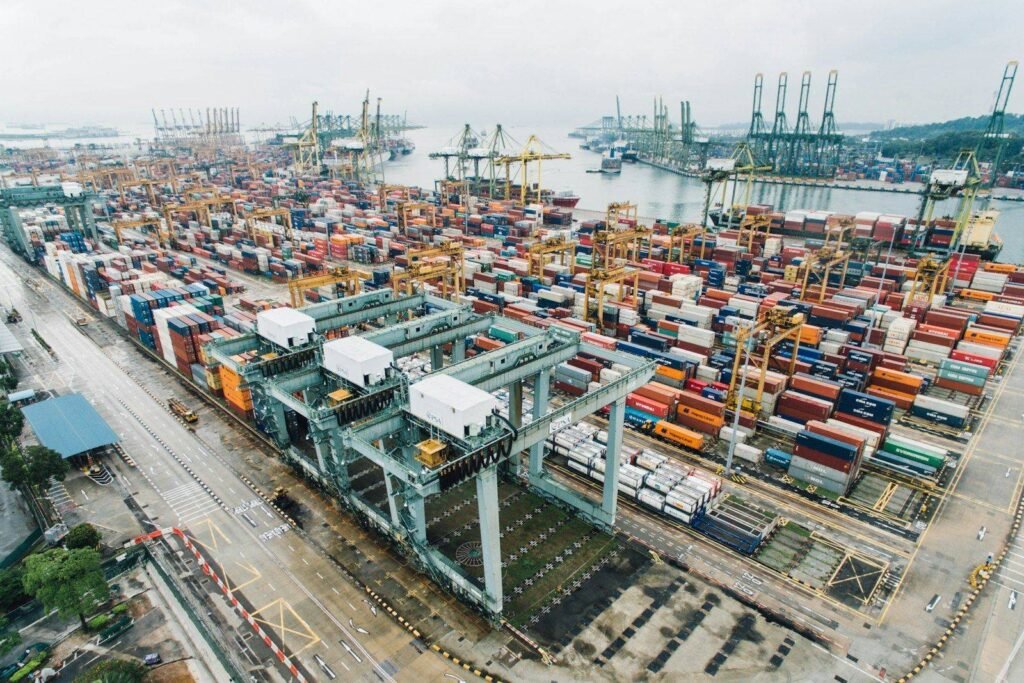 Aerial view of a container terminal with gantry cranes loading a cargo ship